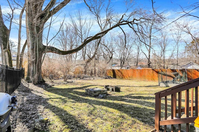 view of yard featuring fence and an outdoor fire pit