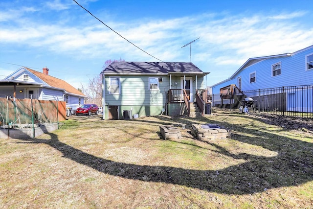 back of house featuring central AC unit and fence