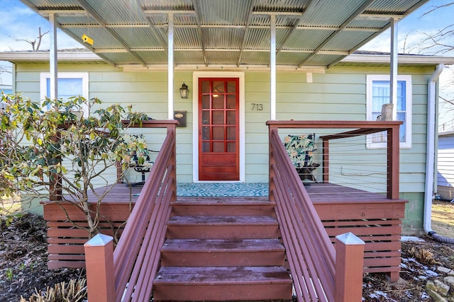 view of exterior entry with covered porch