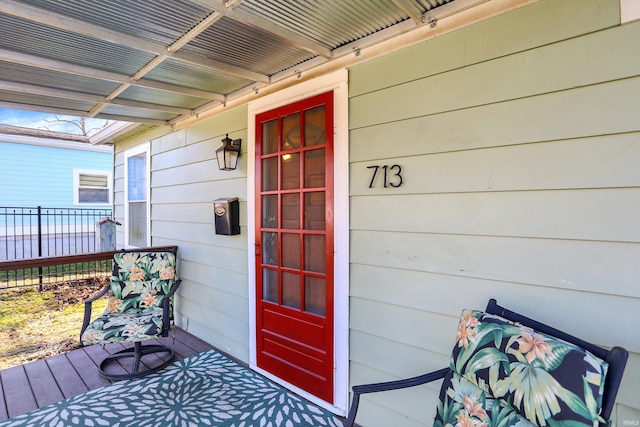 entrance to property featuring fence