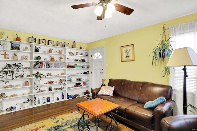 living room with a ceiling fan and wood finished floors