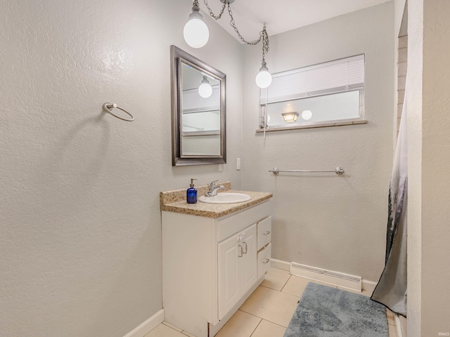 bathroom featuring tile patterned flooring, vanity, visible vents, and baseboards