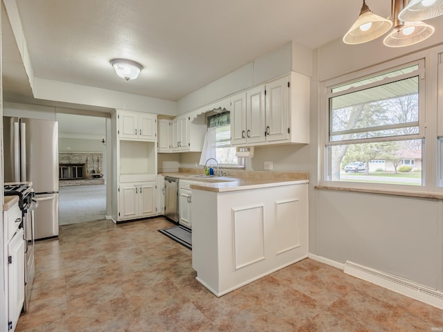 kitchen with a sink, light countertops, a baseboard radiator, stainless steel appliances, and light floors
