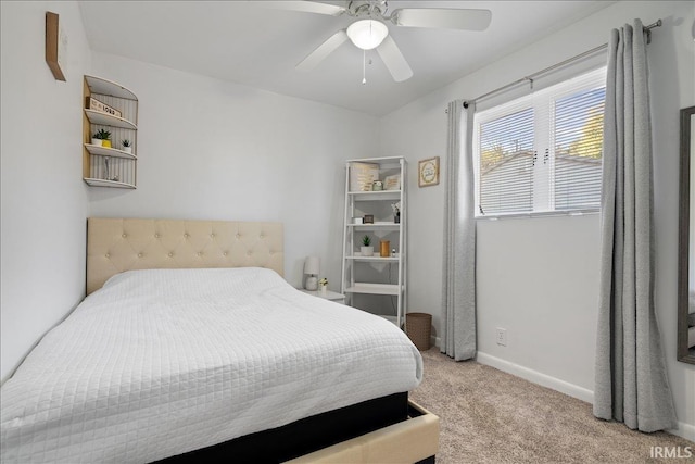 carpeted bedroom with baseboards and a ceiling fan