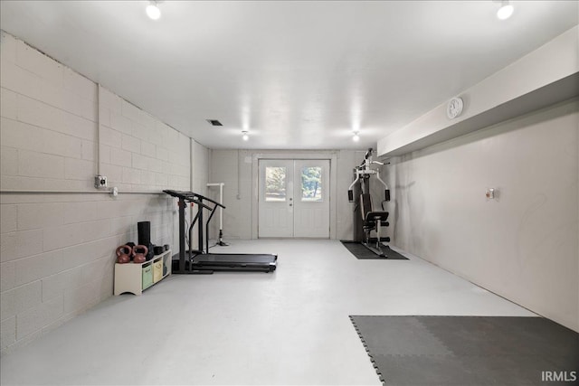 workout room featuring concrete block wall