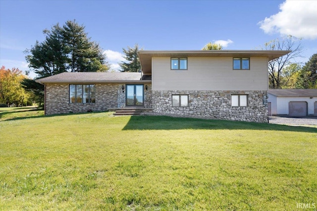 split level home with stone siding, french doors, and a front yard