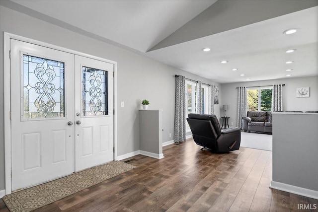 entryway with dark wood-style flooring, baseboards, vaulted ceiling, and recessed lighting