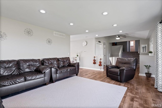 living area with lofted ceiling, visible vents, recessed lighting, and wood finished floors