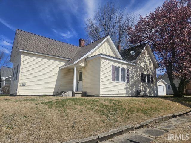 exterior space with a yard and a chimney