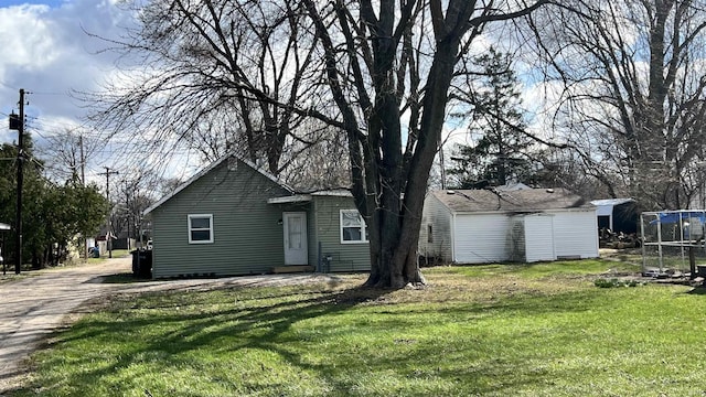 rear view of house featuring a yard