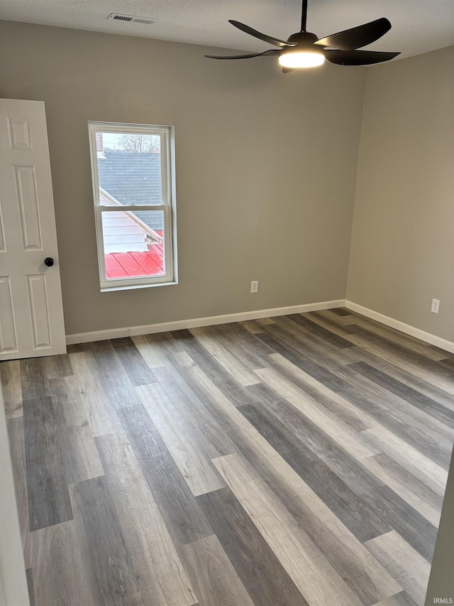 309 E S St, Eaton, IN 47338 - spare room featuring ceiling fan, dark wood finished floors, and baseboards