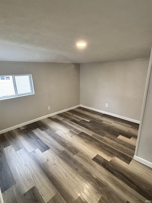 309 E S St, Eaton, IN 47338 - unfurnished room featuring dark wood-type flooring, baseboards, and recessed lighting