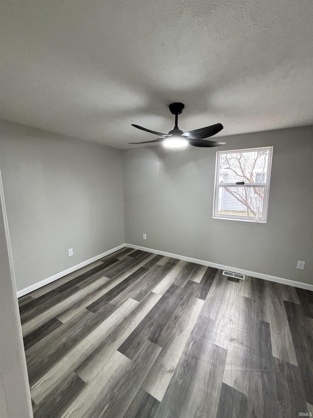 309 E S St, Eaton, IN 47338 - spare room with a ceiling fan, dark wood-style floors, a textured ceiling, and baseboards