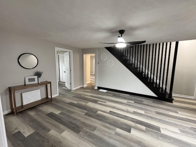 309 E S St, Eaton, IN 47338 - unfurnished living room with ceiling fan, wood finished floors, baseboards, and stairs