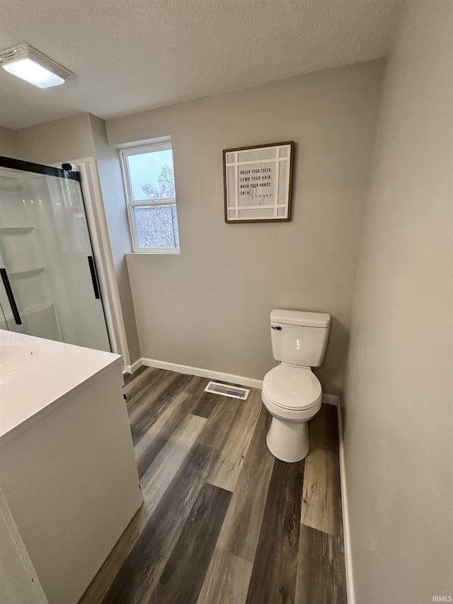 309 E S St, Eaton, IN 47338 - full bathroom featuring toilet, a stall shower, wood finished floors, baseboards, and vanity
