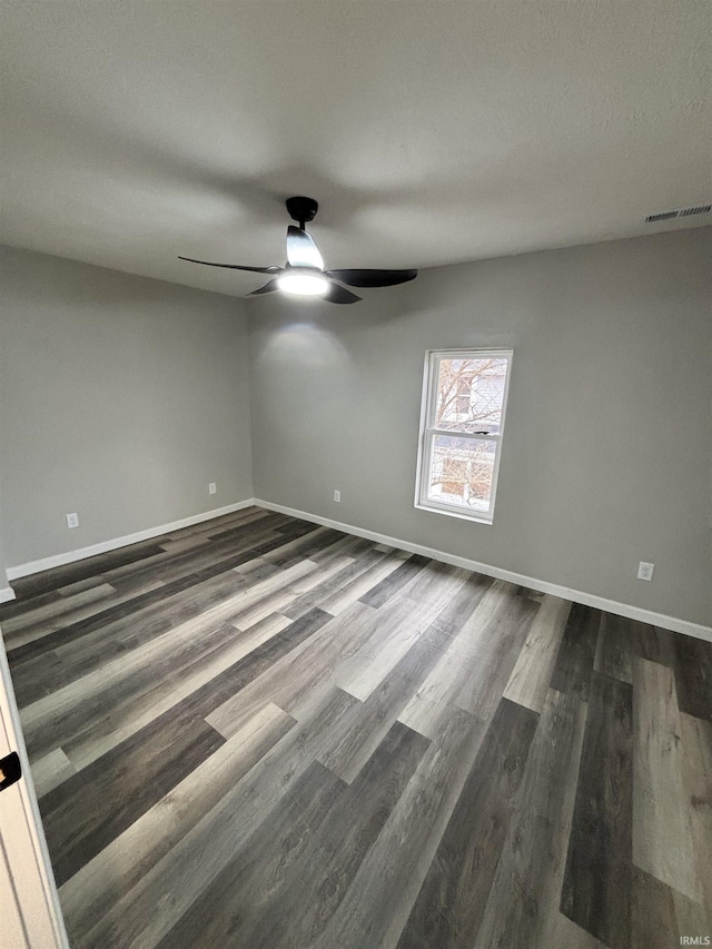 309 E S St, Eaton, IN 47338 - empty room featuring ceiling fan, dark wood-style flooring, and baseboards