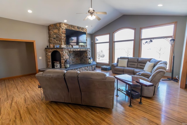 2723 E Kammerer Rd, Kendallville, IN 46755 - living room with ceiling fan, vaulted ceiling, light wood-style floors, and a stone fireplace