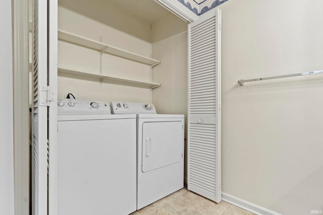 416 Maple St, Tipton, IN 46072 - clothes washing area featuring baseboards, washing machine and dryer, laundry area, and light tile patterned floors