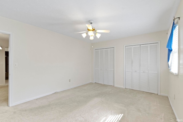 416 Maple St, Tipton, IN 46072 - unfurnished bedroom with baseboards, two closets, carpet floors, and a ceiling fan