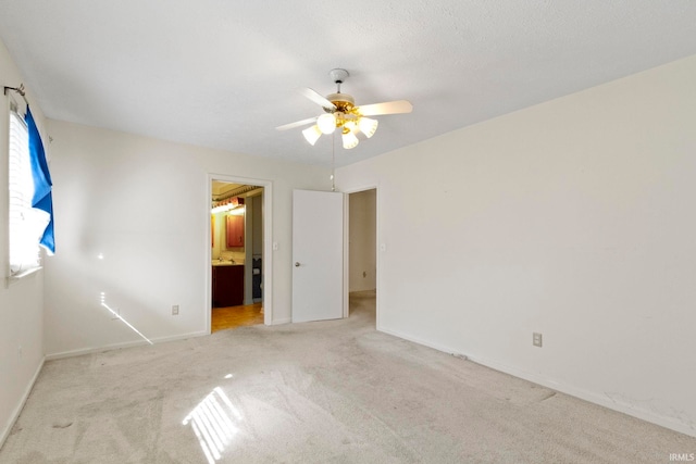 416 Maple St, Tipton, IN 46072 - unfurnished bedroom with light colored carpet, ensuite bath, ceiling fan, and baseboards