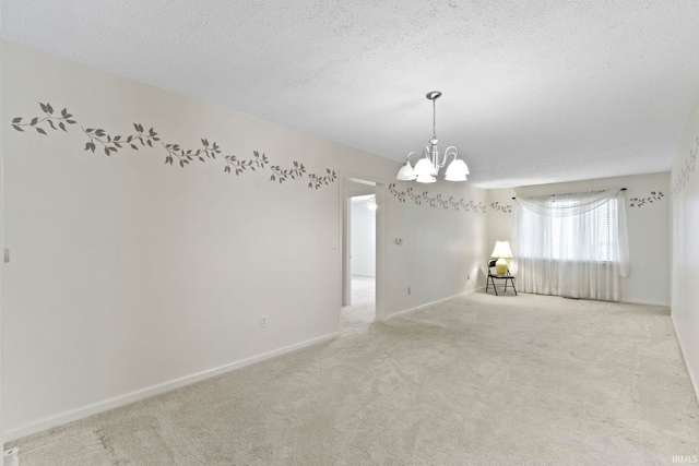 416 Maple St, Tipton, IN 46072 - empty room featuring an inviting chandelier, carpet, baseboards, and a textured ceiling