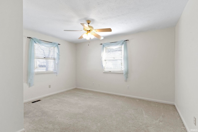 416 Maple St, Tipton, IN 46072 - spare room featuring baseboards, carpet floors, ceiling fan, and a textured ceiling