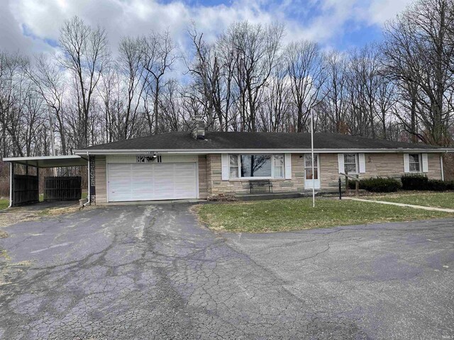 single story home with a front yard, a garage, stone siding, and aphalt driveway
