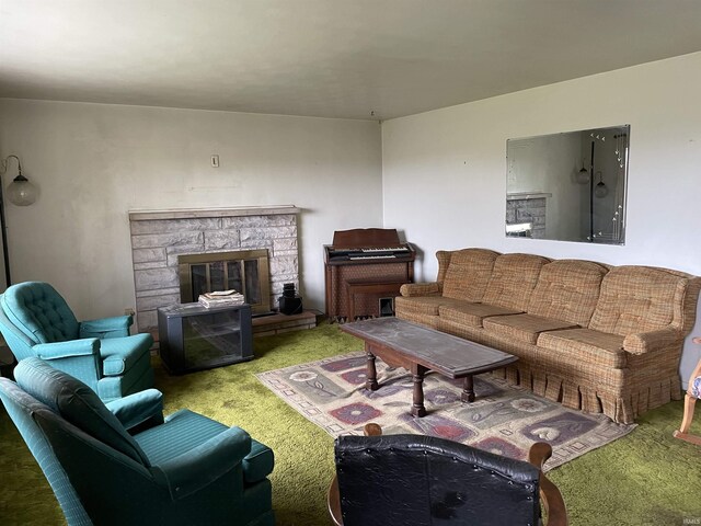 living room featuring a stone fireplace and carpet