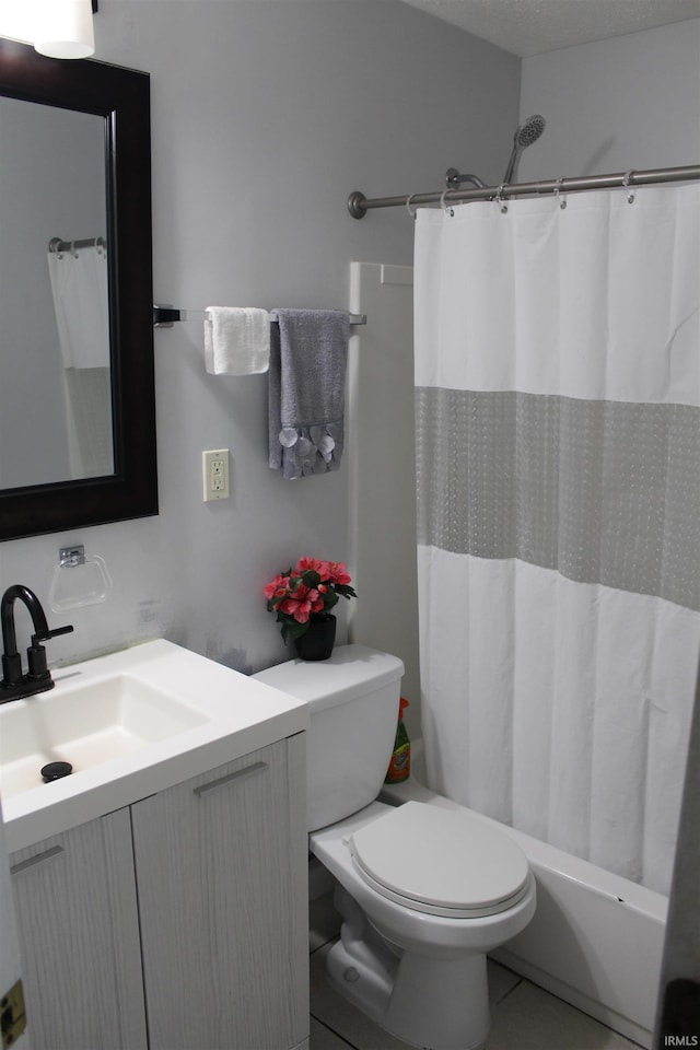 bathroom featuring toilet, vanity, shower / bath combo, and a textured ceiling