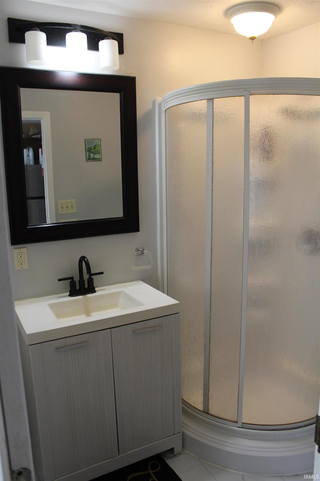 bathroom featuring vanity and a stall shower
