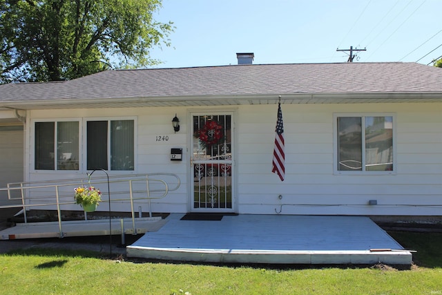 exterior space featuring roof with shingles