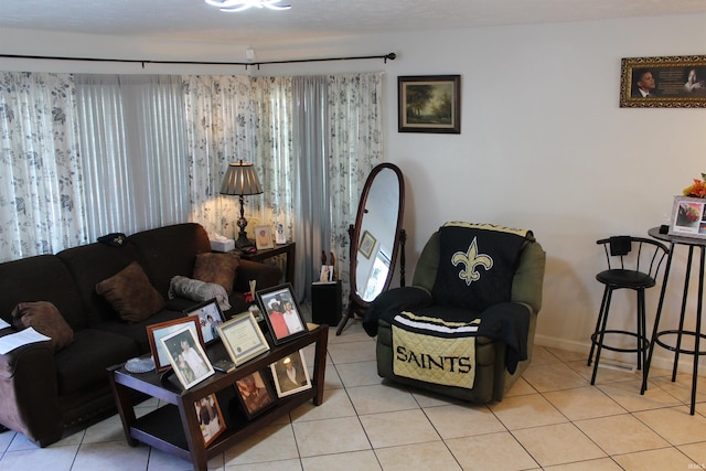 living room featuring light tile patterned flooring and baseboards