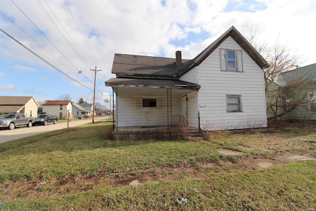 rear view of house with a yard
