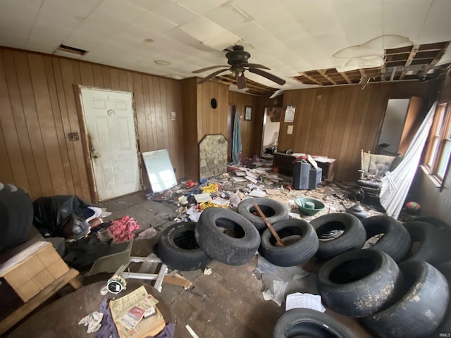 misc room with wood walls and a ceiling fan