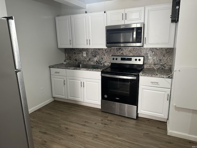 112 W Bond St, Attica, IN 47918 - kitchen featuring white cabinets, backsplash, and stainless steel appliances