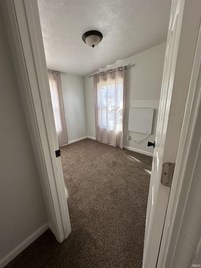 112 W Bond St, Attica, IN 47918 - empty room featuring baseboards, carpet floors, and a textured ceiling