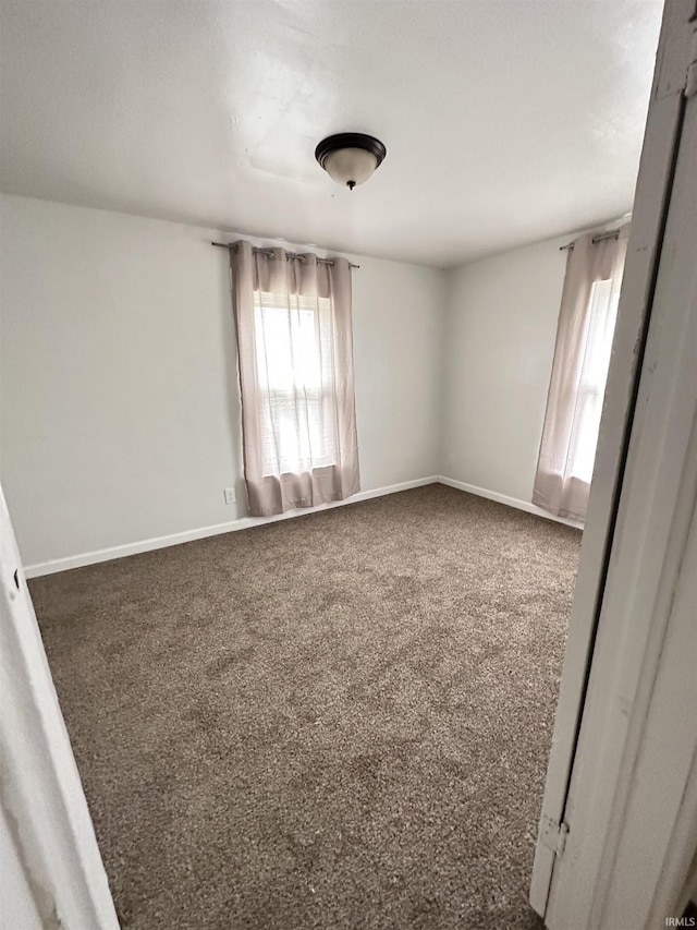 112 W Bond St, Attica, IN 47918 - empty room with baseboards and carpet flooring