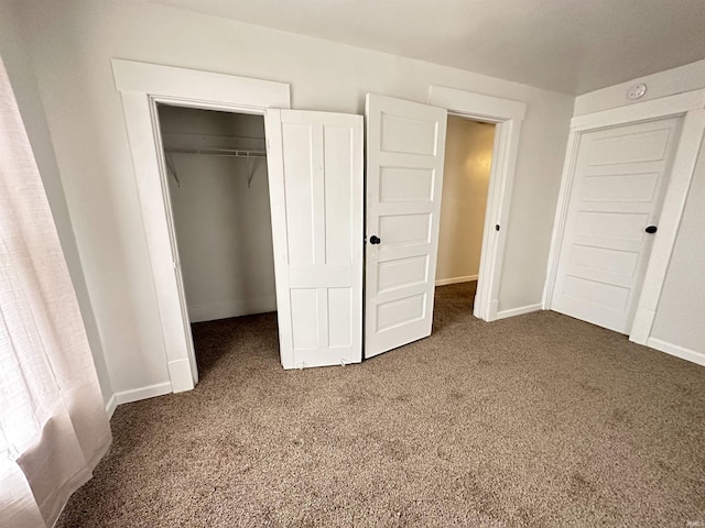 112 W Bond St, Attica, IN 47918 - unfurnished bedroom with baseboards, dark carpet, and a closet