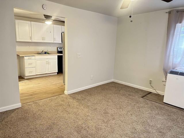 112 W Bond St, Attica, IN 47918 - interior space with light colored carpet, baseboards, and a ceiling fan