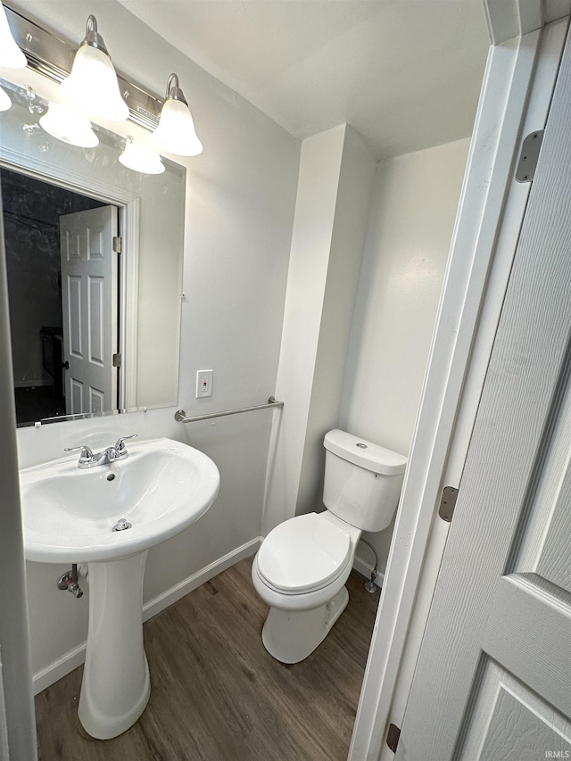 112 W Bond St, Attica, IN 47918 - bathroom with toilet, wood finished floors, and baseboards