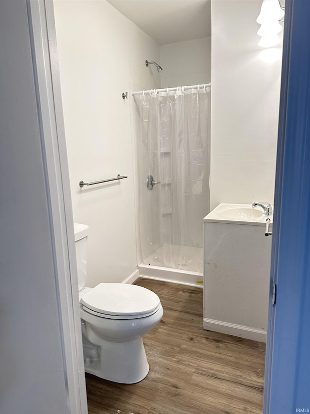 112 W Bond St, Attica, IN 47918 - full bath with toilet, a sink, a stall shower, and wood finished floors
