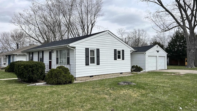 view of side of home with crawl space, an outbuilding, a garage, and a yard