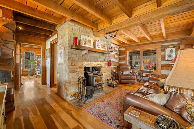 5175 Beanblossom Rd, Nashville, IN 47448 - living room with hardwood / wood-style floors, a wood stove, wood ceiling, and beam ceiling