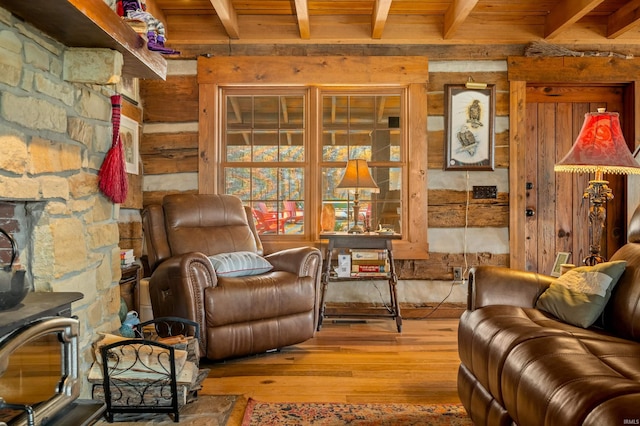 5175 Beanblossom Rd, Nashville, IN 47448 - sitting room with wooden ceiling, beam ceiling, wood finished floors, wood walls, and a wood stove
