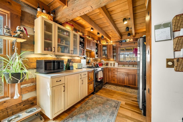 5175 Beanblossom Rd, Nashville, IN 47448 - kitchen with light countertops, wooden ceiling, a sink, light wood finished floors, and appliances with stainless steel finishes