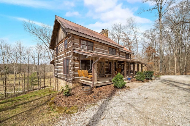 5175 Beanblossom Rd, Nashville, IN 47448 - log home with a chimney, log siding, a porch, and metal roof