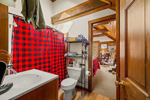 5175 Beanblossom Rd, Nashville, IN 47448 - full bathroom with a shower with curtain, toilet, vanity, and wood finished floors