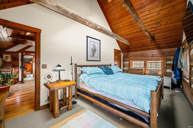 5175 Beanblossom Rd, Nashville, IN 47448 - carpeted bedroom featuring high vaulted ceiling, wood walls, beamed ceiling, baseboards, and wood ceiling
