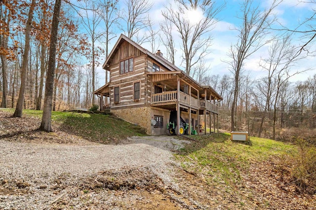 5175 Beanblossom Rd, Nashville, IN 47448 - exterior space featuring a chimney, cooling unit, a wooden deck, board and batten siding, and log exterior