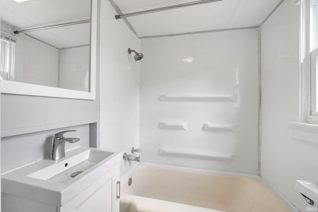 bathroom with toilet, vanity, and shower / bathtub combination